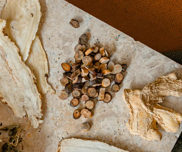 Small pile of wooden herbs on a textured surface with a blurred background