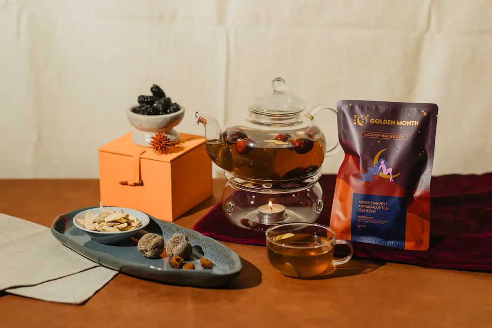 Tea set with a teapot, tea bag, and snacks on a wooden table.