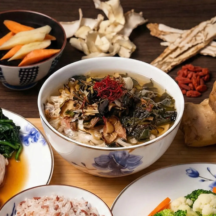 Bowl of soup with various ingredients on a wooden table