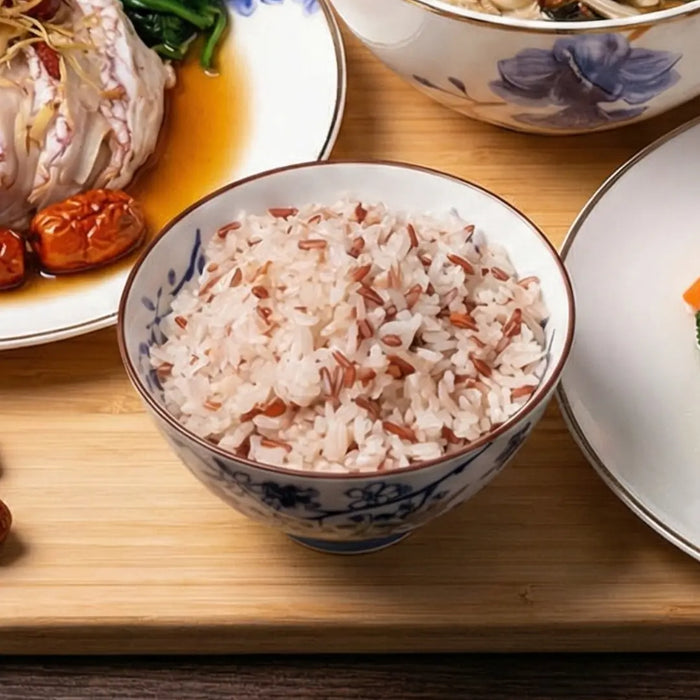 Bowl of rice with a floral pattern on a wooden table