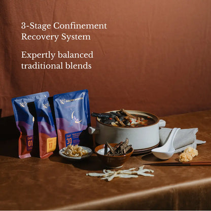 Three packages of a 3-stage confinement recovery system soup on a table with a bowl of food and ingredients.